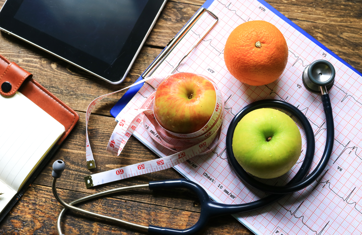 fruit, stethoscope, vital sign readout, notebook