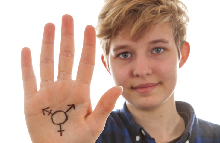 individual with transgender symbol written on hand
